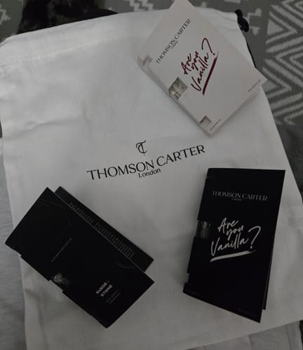 Customer's 'Are You Vanilla Night' and other perfume samples displayed on a branded white dust bag.