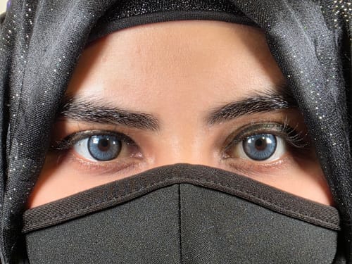 Close-up of a reviewer wearing the vibrant Norko Blue Prescription Colored Contact Lenses.