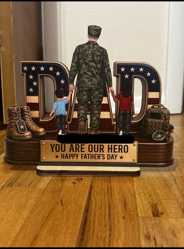 Customer's personalized wooden plaque featuring a military dad and two kids in front of the word 'DAD' with a US flag design.