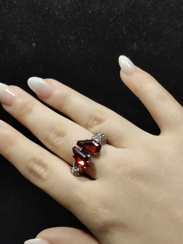 Reviewer wearing the Promise Ring, showing its two red, coffin-shaped stones on their finger.