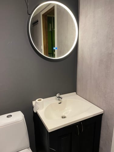 Kundebilde som viser den koksgrå supermatte kontaktplasten på veggen ved siden av en vask.