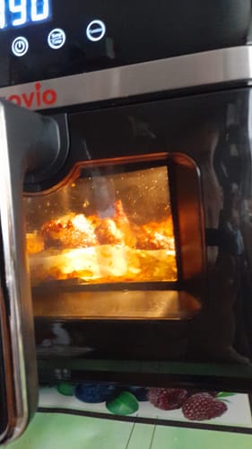Customer's Air Fryer Novio StonePro in use, with food cooking inside the illuminated basket.