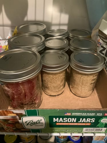 Customer's pantry showing various mason jars filled with dried goods, sealed with the Mason Genie Vacuum Sealer.