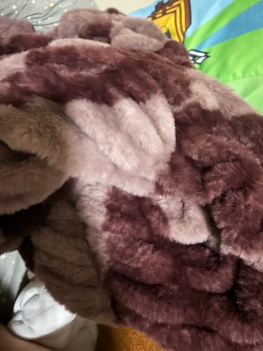 Close-up of a customer's plush Hugs Shelby Mulberry Diamond Blanket, showing the soft texture and rich color pattern.