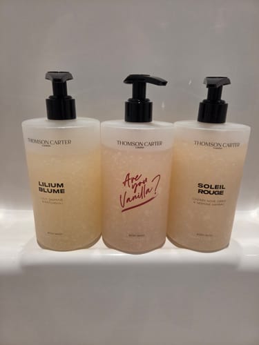 Customer's Soleil Rouge Body Wash shown with two other scents from the brand on a shelf.