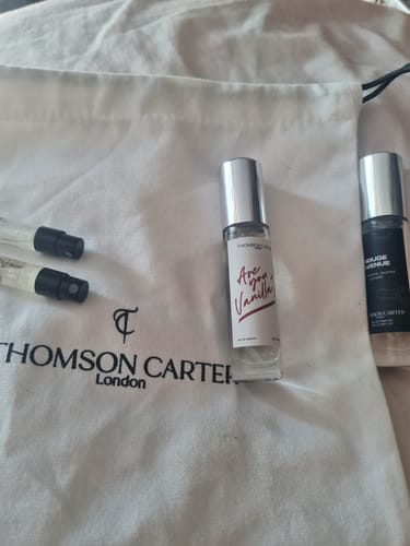 Customer's bottle of Are You Vanilla? Day perfume displayed on a white branded pouch with other fragrance vials.