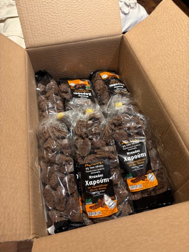 Customer photo shows six bags of Carob croutons, the family pack, inside a cardboard shipping box.