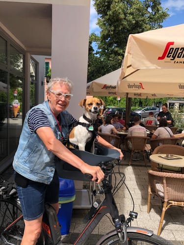 Reviewer with their dog in a Kvisp seat on a bike, the item the Combination Lock is designed for.