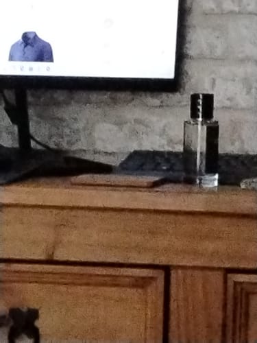 Customer's Smoke & Mirrors bottle sitting on a wooden desk next to a computer monitor.