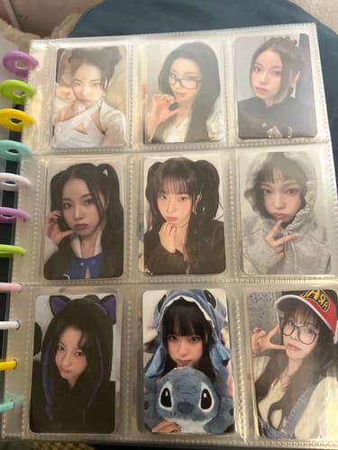 Customer's collection of NMIXX photocards, including the "Heavy Serenade" photocard, arranged in a nine-pocket binder page.