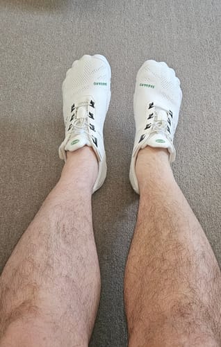 Customer wearing white Free I - Barefoot Shoes, showing the product's wide toe box.