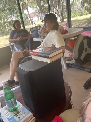 Customers relaxing on a screened-in porch, a scene shared with their review of Royal Cherry.