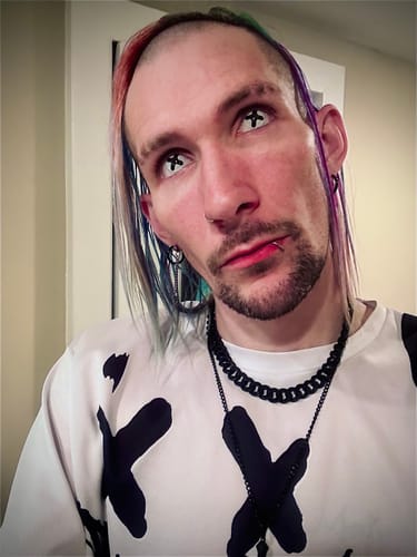 Close-up of a reviewer wearing the white Cosplay Black Cross Colored Contact Lenses with a black cross pattern.