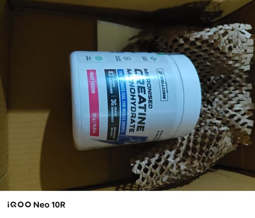 Customer's tub of Wellcore Micronised Creatine Monohydrate in Fruit Fusion flavor, shown inside the shipping box.