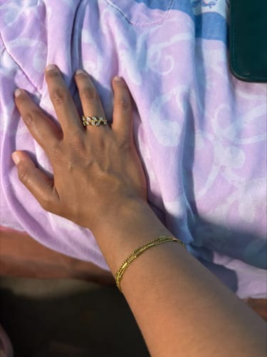 Reviewer wearing the gold Sabina Triple Layered Bracelet on their wrist.