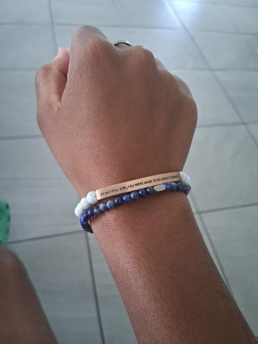 Customer wearing the Blue Lapis Accent Bracelet on their wrist, styled with an engraved bracelet.