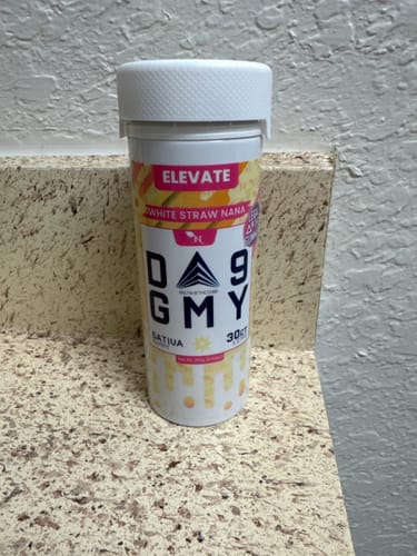 Customer's bottle of White Straw Nana Sativa Delta 9 Gummies sitting on a speckled countertop.