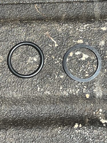 Reviewer's photo of the replacement O-ring and original flat washer for the 2.5 Gallon Jug.