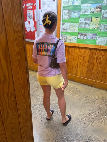 Reviewer from behind showing the fit of the yellow W130 Amore Scrunch Shorts for everyday wear.