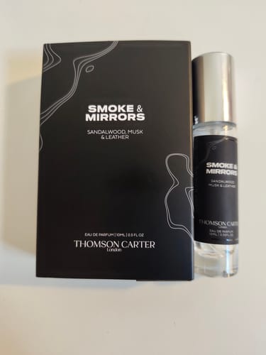 Customer's bottle of Smoke & Mirrors Eau de Parfum standing next to its black product box.