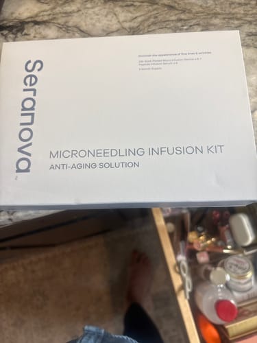 Reviewer shows the box for the Seranova Microneedling Infusion Kit on a counter.
