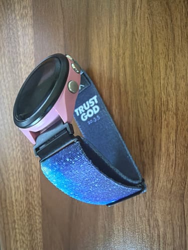 Reviewer's galaxy-print Trust God Bible Verse Watchband attached to a watch, showing the "TRUST GOD" text on the inner band.