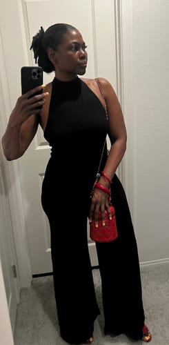 Customer wearing the black Smooth Halter Wide Leg Jumpsuit, showing the halter neckline and fit.