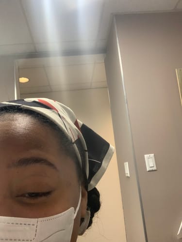 Close-up of a reviewer wearing the Gamble Bandana as a headscarf indoors.