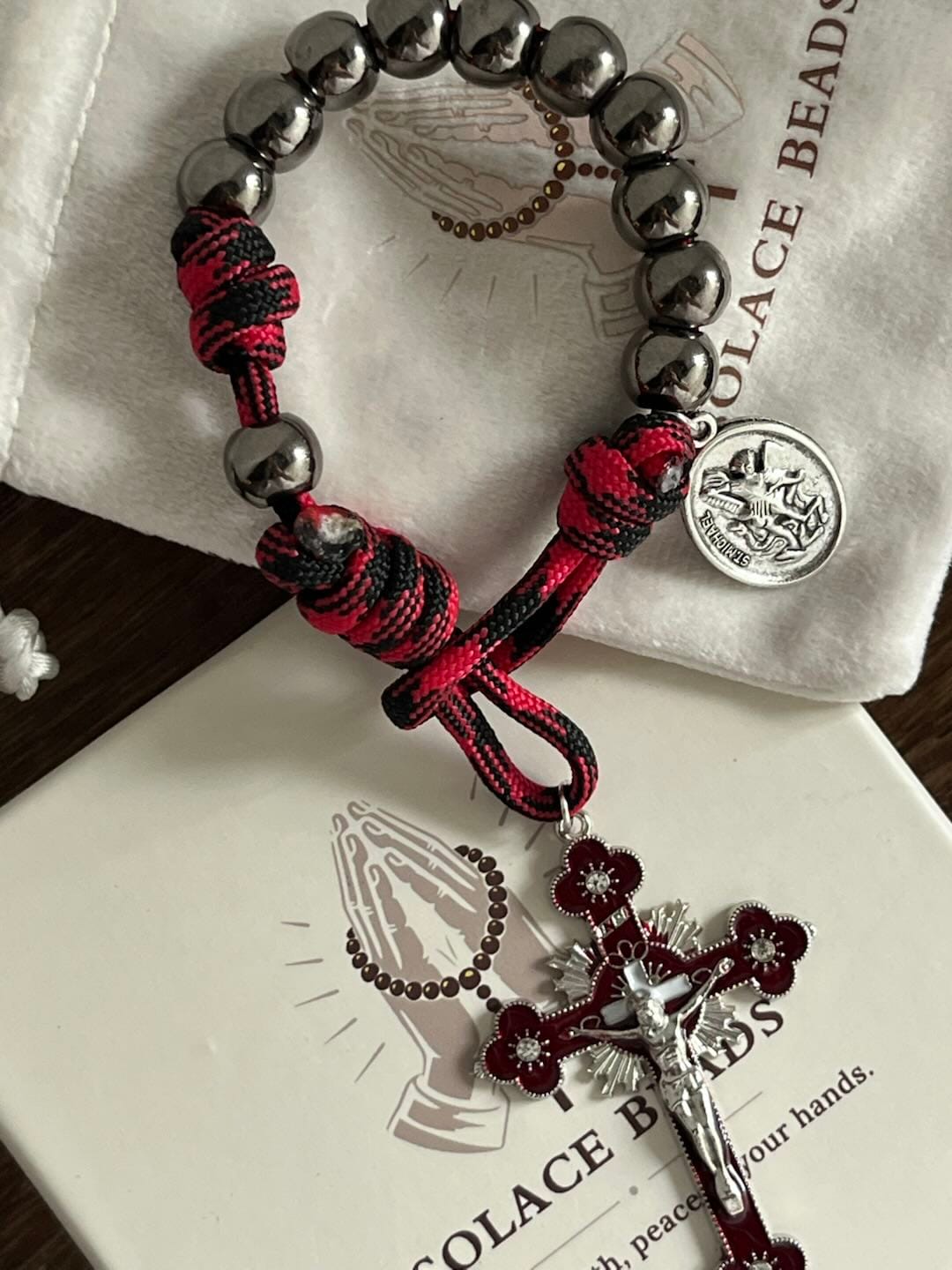 Customer photo review of Solacebeads Gunmetal Bead Car Rosary & Red Enamel Crucifix: Rooted In St. Michael Protection