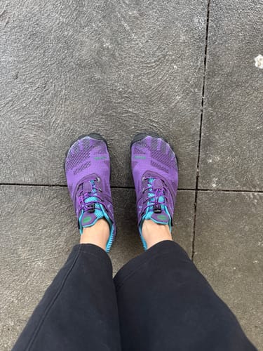 Reviewer wearing purple and turquoise Free I - Barefoot Shoes, showing the wide toe box from a top-down view.
