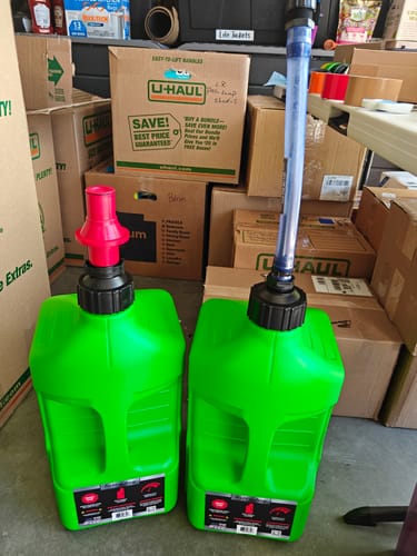 Customer's two green 5 Gallon Jugs, one with a red ripper cap and the other with a long auto-stop nozzle.