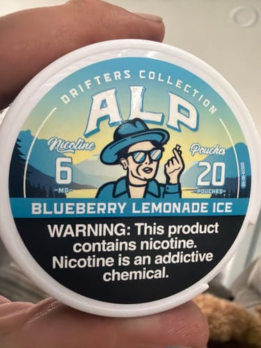 Customer holding a white tin of Drifters Blueberry Lemonade Ice Nicotine Pouches.