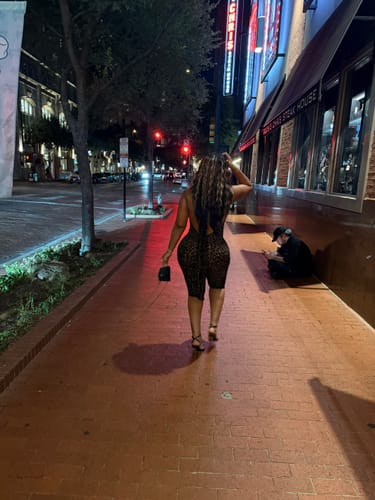 Back view of the reviewer walking in the burnout print capri jumpsuit, showing the open-back design.