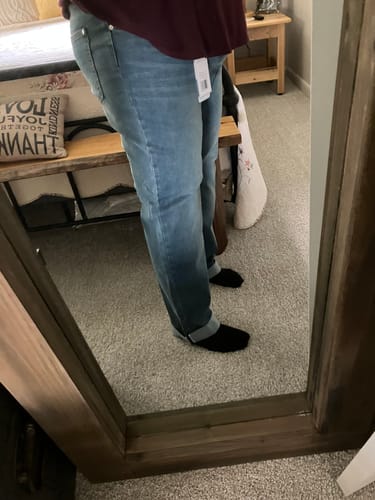 Customer's side view of the light wash Judy Blue Boyfriend Jeans, showing the relaxed fit with cuffed ankles.