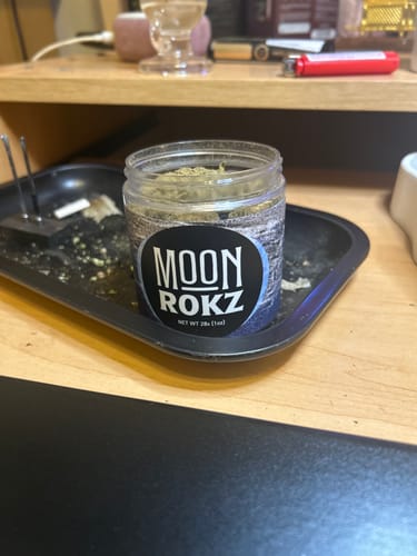 A customer's photo showing their delivered product, a small jar on a black tray.