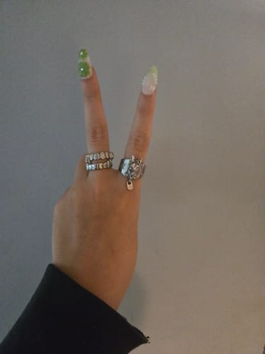 Customer's hand in a peace sign, wearing the silver UPGRADED HELLHOUND RING on the index finger.
