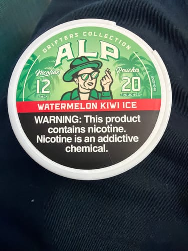 Customer's can of Drifters Watermelon Kiwi Ice Nicotine Pouches resting on a dark fabric surface.