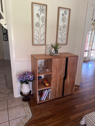 Customer's Aurélien Botanical Wall Art set hanging above a wooden sideboard in an entryway.