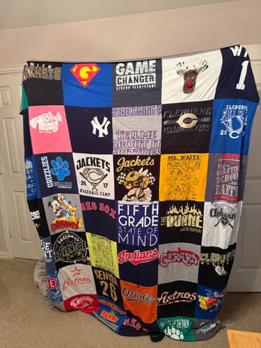 Customer's completed Project Repat T-Shirt Quilt, a large keepsake featuring various sports and school t-shirts.