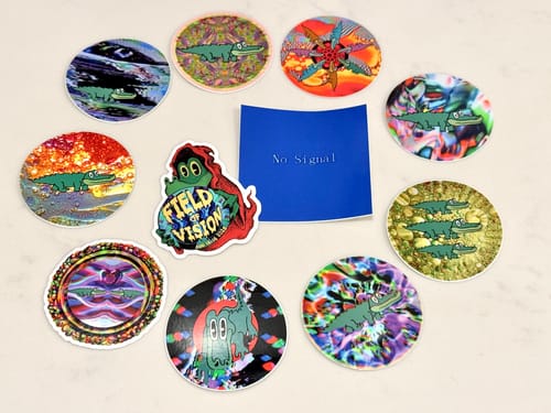 Customer's assortment of custom vinyl stickers with colorful designs featuring a cartoon alligator.