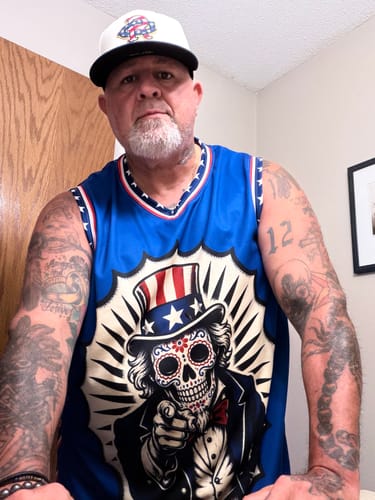Customer wearing the blue 4th of July Calacas Basketball Jersey, showing the detailed front graphic.