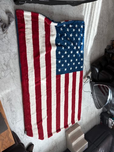 Customer's large, soft Lush Flag Blanket with an American flag design spread out completely on a floor.