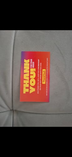 Customer photo of a 'Thank You' card with a discount code received with their vape order.