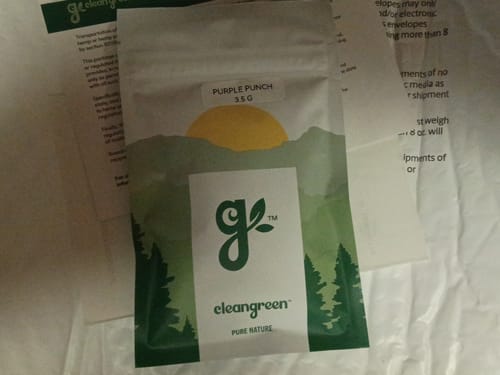 Customer's white and green pouch containing their Purple Punch product.