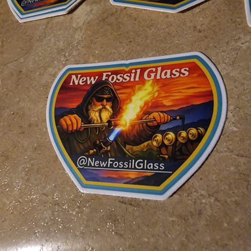 Customer's vibrant Cut to Shape Sticker featuring a glassblower illustration, with a crisp white border.