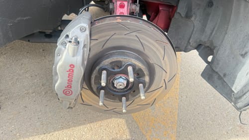 Customer's close-up of a black Wheel Spacer installed on a vehicle's hub assembly, with the brake caliper visible.