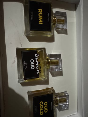 Customer's three perfume bottles from the OUD Supreme BUNDLE shown lying in their white box.