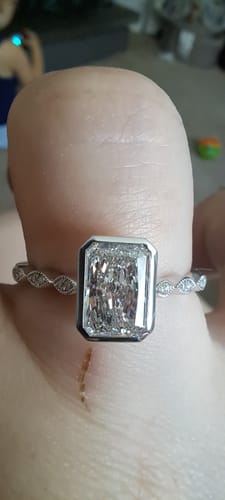 Customer's hand showing the beautiful Doveggs bezel vintage ring with a rectangular stone and tiny milgrain on the band.