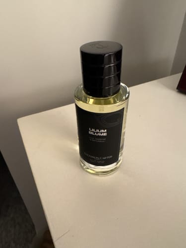 Customer's Lilium Blume Eau de Parfum bottle with a black label and cap, sitting on a white surface.