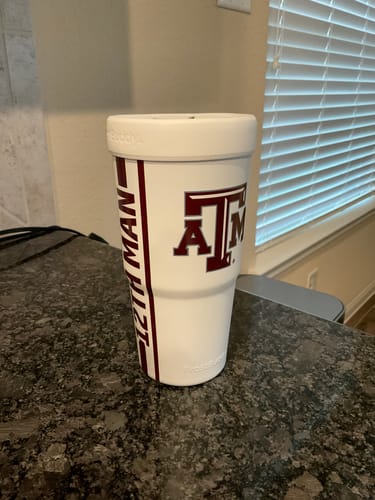 Customer's white To-Go Buddy insulator with Texas A&M Aggies branding on a granite countertop.